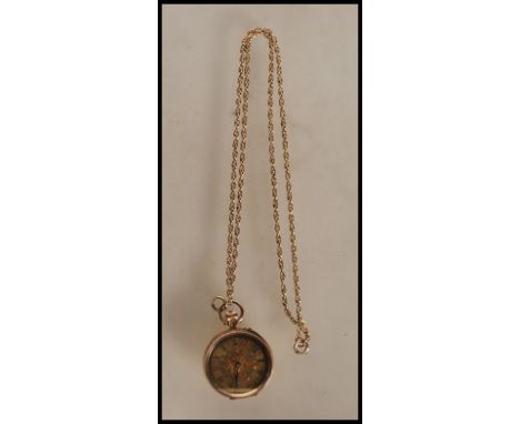 A stamped 14ct gold pocket fob watch having a gilt dial with scrolled foliate detailing with roman numerals to the chapter ri