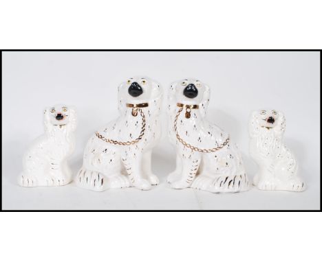 Two pairs of late 19th / early 20th century Victorian King Charles Spaniel ceramic Staffordshire figures including two gradua