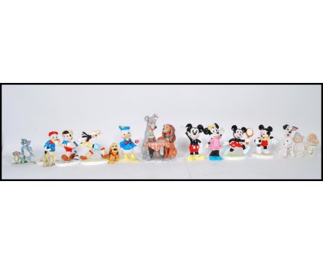 A group of vintage ceramic Disney figurines including a selection of Mickey and Minnie figures, Daffy duck, Tom and Jerry wad