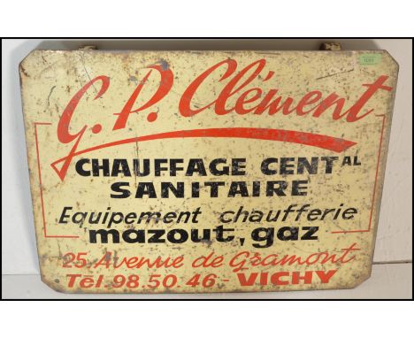 A vintage French 20th Century enameled metal advertising sign with cream ground and red and black details for G. P. Clement C