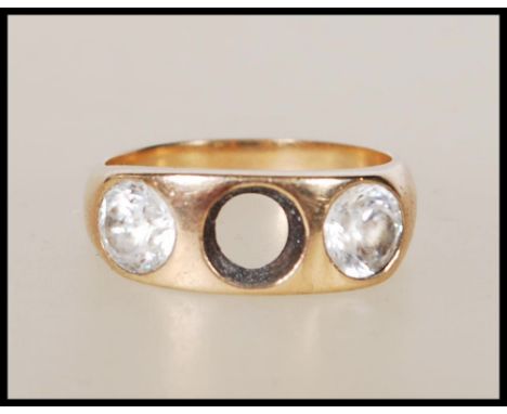 A stamped 9ct gold ring set with two round cut white stones (one missing). Tests as 9ct gold. Weight 7.1g. Size T.&nbsp;