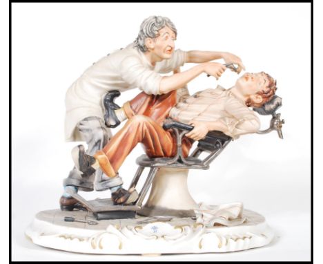 A Capodimonte ceramic figurine depicting a dentist extracting a tooth from a patient, raised on a scrolled design base, signe