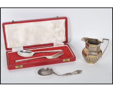 A collection of silver items to include a silver hallmarked fork and spoon set by Oliver &amp; Bower Ltd, a silver hallmarked