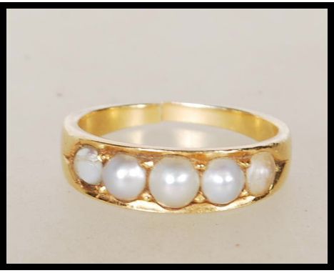 A vintage 18ct yellow gold ring set with five graduating pearls. Unmarked but tests as 18ct with stamp marks for RJ 18. Gross