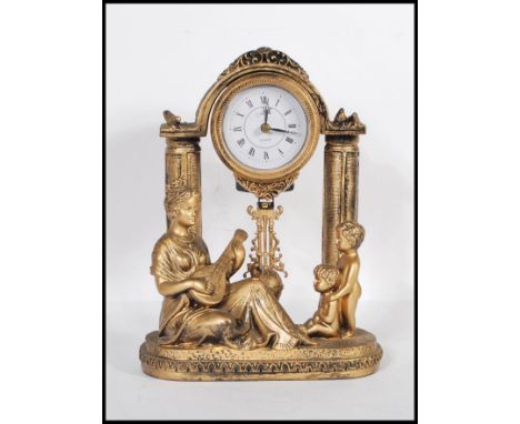 A contemporary Juliana figural pendulum quartz clock, the movement held aloft on classical columns, with a classical female f