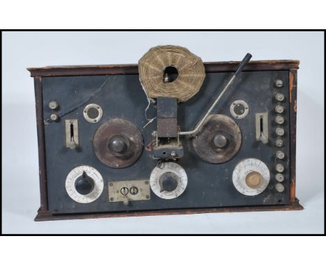 A early 20th Century vintage pine cased Crystal radio receiver&nbsp;having&nbsp;dial and switches to front with hinged lid op