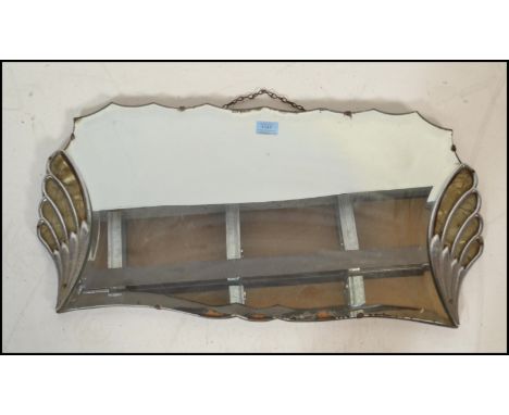 A vintage Art Deco 1920's frameless bevelled glass mirror having a symmetrical fanned design to either side with celluloid pa