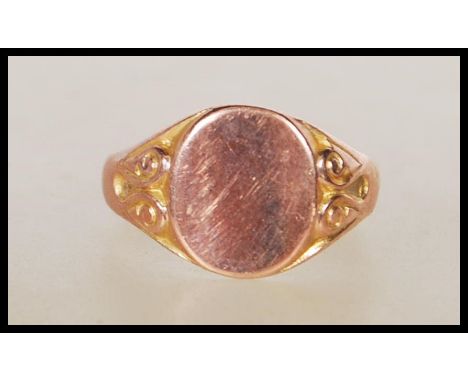 A hallmarked 9ct gold signet ring having an oval head with scrolled shoulders. Hallmarked Birmingham 1949. Size R.