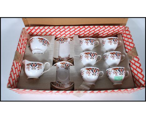 A vintage Coclough tea service consisting of tea cups and saucers having red and blue Imari style transfer printed decoration