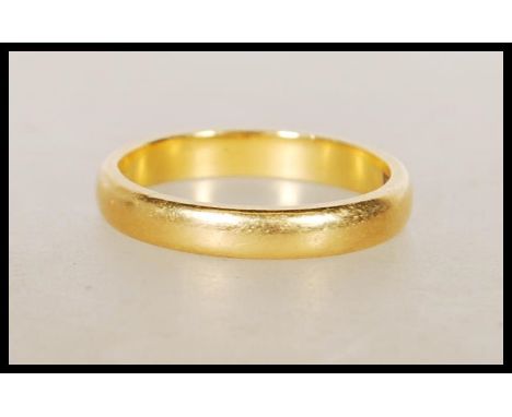 A hallmarked 22ct gold wedding band ring. Hallmarked Birmingham 1960. Weight 3.6g. Size K.5.