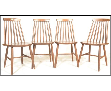 A group of four vintage mid 20th Century Ercol style spindle back dining chairs, raised on turned legs with H stretchers. Mea