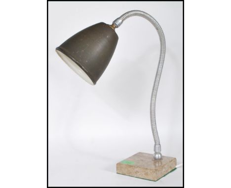 A retro 20th Century table desk lamp having dark green enamel pendant shade on a chrome gooseneck adjustable stem. Raised on 