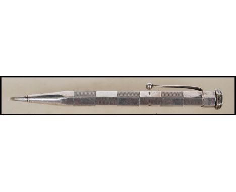 An early 20th Century Sterling silver propelling pencil of hexagonal form having sectional engine turned decoration. Patent n