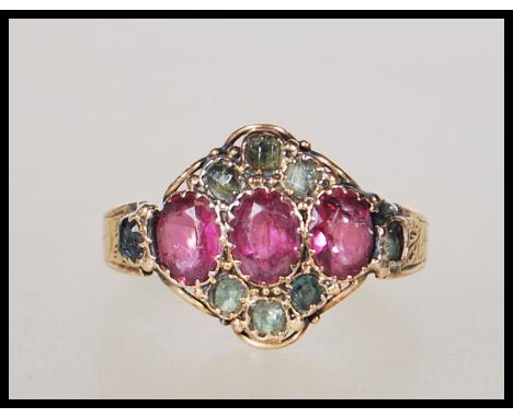 A 19th Century Victorian 15ct gold ring set with three oval cut pink stones flanked by green accent stones. Hallmarked Birmin