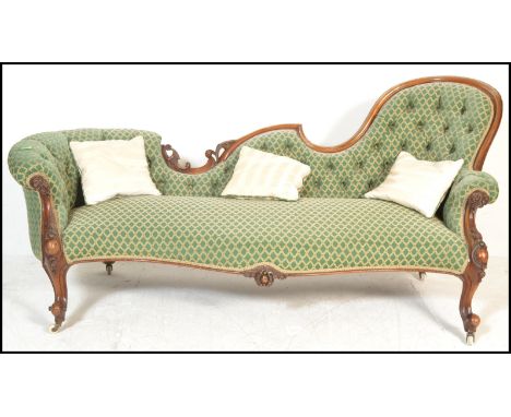 A 19th Century Victorian walnut show frame scroll back sofa, button upholstered in green dralon raised on carved foliate shap