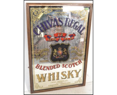 A 20th Century pub advertising mirror for&nbsp;Scottish Chivas Regal. The mirror with scrolling borders and purple Chivas Reg