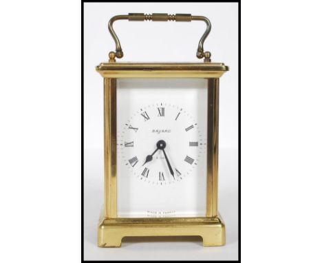 A mid-20th century French 8 Day carriage clock by Bayard. The brass case with glass viewing panels and the dial stamped ' Mad