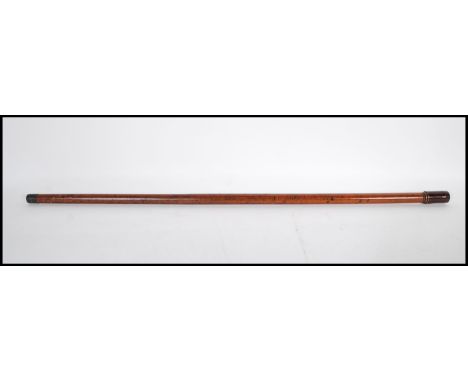 A 20th Century concealed pipe walking stick cane having a dark wood knop which removes to form a pipe bowl with the mouth pie