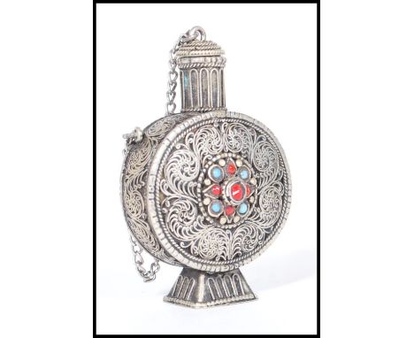 A late 19th / early 20th Century Chinese silver opium snuff / scent perfume bottle of moon flask shape having filigree scroll