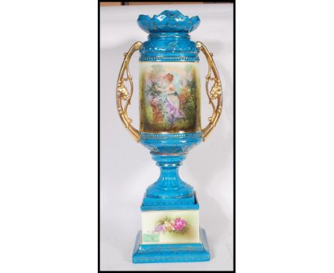 A early 20th Century&nbsp;Continental twin handled ceramic urn vase having a blue turquoise painted ground with central class