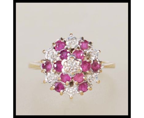 A hallmarked 9ct gold ladies dress ring having a round head illusion set with with pink and white stones. Weight 2.6g. Size K