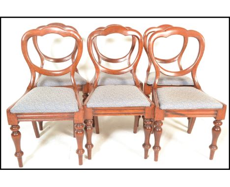 A set of six 19th Century Victorian mahogany balloon back dining chairs, upholstered stuffed seats raised on ring turned tape