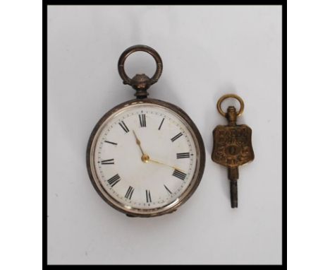 A 20th Century silver fob pocket watch having a white enamelled face with roman numeral chapter ring having gilt hands, the h