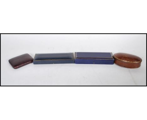 A group of four vintage early 20th Century watch boxes to include a brown leather domed box with a blue velvet interior, mark