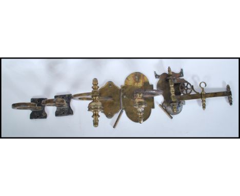 A small group of vintage brass brackets to include two carriage lantern holders, adjustable wall mounted bracket with finial 