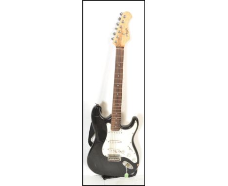 A vintage 20th Century Nevada stratocaster style electric guitar having black paintwork to the body with a white scratch guar