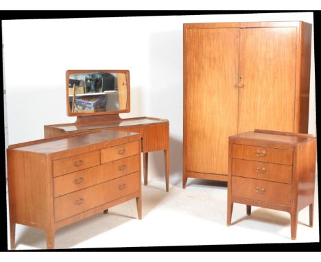 A vintage mid 20th Century bedroom suite consisting of double wardrobe,&nbsp; matching kneehole dressing table with&nbsp; mir