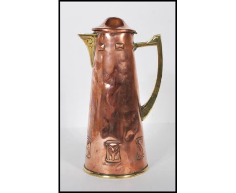 An late 19th Century / early 20th Century WMF arts and crafts pitcher / lidded jug having repousse Art Nouveau style decorati