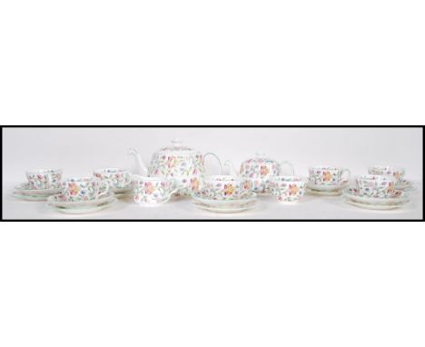 A vintage Minton tea service in the Harron Hall pattern decorated with pink and green floral sprays, consisting of side plate