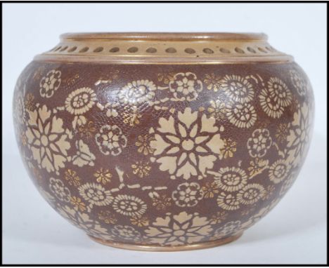 A 19th century Victorian Doulton Lambeth planter pot of bulbous form having two tone floral and gilt textured decoration to t