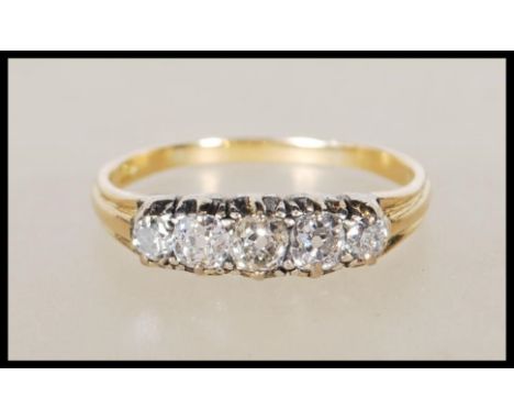 A stamped 18ct yellow gold ring set with five diamonds of approx 90pts. Ring size T. Gross weight 3.4g&nbsp;