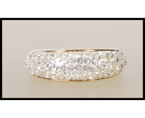 A stamped 375 9ct gold ladies cluster ring set with four rows of white accent stones to the head. Weight 3.2g. Size P.5.