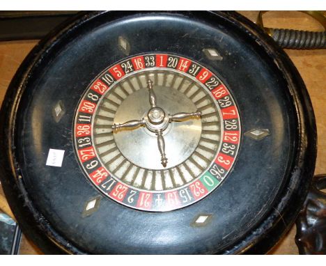 A VINTAGE ROULETTE WHEEL AND TABLE COVER TOGETHER WITH VARIOUS BONE AND OTHER COUNTERS.  (QTY)