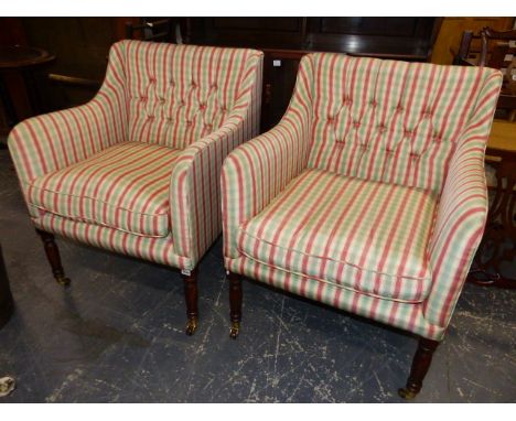 A PAIR OF REGENCY STYLE ARMCHAIRS WITH CHECKERED UPHOLSTERY AND LOOSE SEAT CUSHIONS WITH BRASS AND CERAMIC CASTORS.