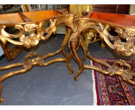 A PAIR OF LOUIS XV STYLE GILT ROUGE MARBLE TOP CONSOLE TABLES, THE SERPENTINE FOLIAGE AND C-SCROLL APRONS ABOVE CABRIOLE LEGS