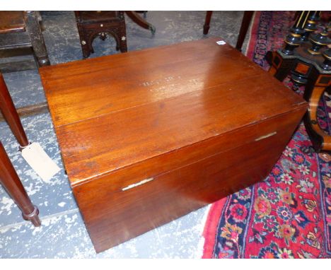 A TEAK TRUNK, THE TOP OF THE RECTANGULAR HINGED LID ONCE PAINTED WITH THE OWNER'S NAME.   68.5 x 47 x H.38.5cms.