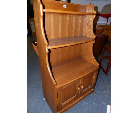 AN ERCOL PALE ELM WATERFALL BOOKCASE WITH CUPBOARD BASE.   61 x 34 x H.101cms.
