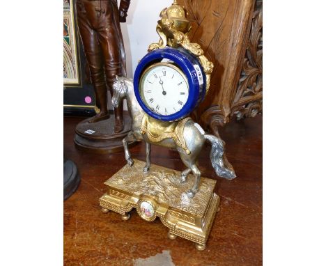 A GILT SILVERED AND BLUE CERAMIC TIMEPIECE SUPPORTED ON THE BACK OF A HORSE.   H.43cms.