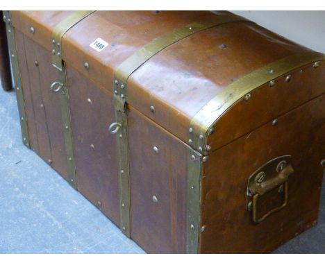 A BRASS BOUND COPPER CLAD TRUNK, THE RECTANGULAR HINGED LID WITH SHALLOW ROUND ARCHED TOP AND OPENING TO REVEAL RED VELVET LI
