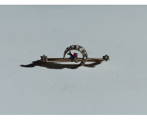 AN OLD CUT DIAMOND, SAPPHIRE AND RUBY CRESCENT MOON BAR BROOCH. WIDTH 4.5cms 