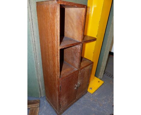 A HEAL'S SMALL OAK BOOKCASE CABINET WITH A TWO DOOR BASE.   40 x 23 x H.87cms.