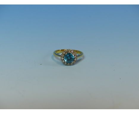 AN 18ct AND PLATINUM BLUE ZIRCON AND DIAMOND CLUSTER RING. FINGER SIZE L.  