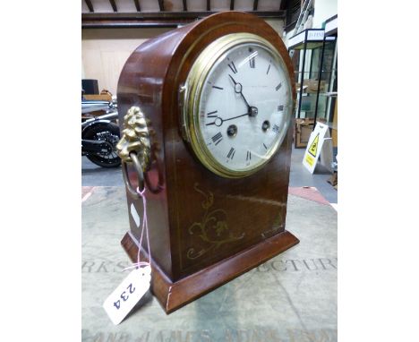 A BRASS INLAID MAHOGANY CASED FRENCH PENDULUM CLOCK STRIKING ON A COILED ROD, THE ROUND DIAL WITH ENGLISH RETAILER'S NAME AND