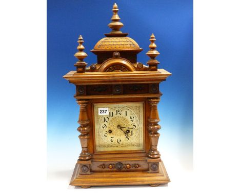 A LATE VICTORIAN WALNUT CASED MANTLE CLOCK WITH PAINTED AND GILT DIAL WITH GONG STRIKE MOVEMENT.