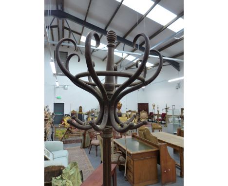 A THONET STYLE BENTWOOD COAT AND STICK STAND, THE REMOVABLE TOP OF SIX HOOKS ON QUATREFOIL SECTIONED COLUMN, THE STICK RING O