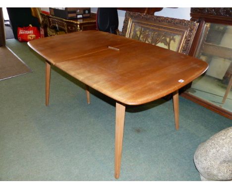 AN ERCOL PALE ELM EXTENDING DINING TABLE WITH TWO LEAVES TOGETHER WITH A SET OF EIGHT ERCOL STICK BACK RAIL TOP SIDE CHAIRS. 